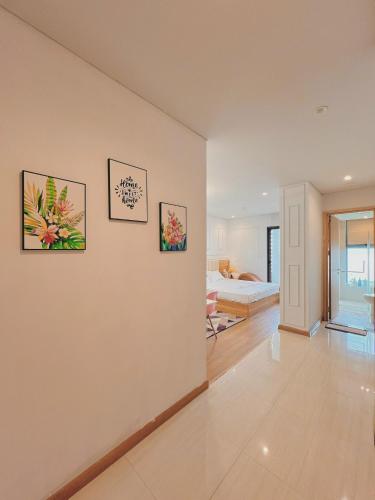 a room with three pictures on the wall at Dreamy'home-Căn Hộ view biển in Ha Long