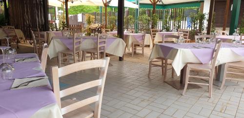 a restaurant with tables and chairs with purple tablecloths at Hotel terme di orte in Orte