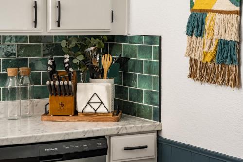 a kitchen counter with a cutting board with knives at Denver Emerald - Close to Red Rocks, Arvada & Downtown in Denver