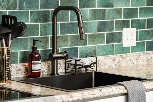 a kitchen sink with a bottle of alcohol next to it at Denver Emerald - Close to Red Rocks, Arvada & Downtown in Denver