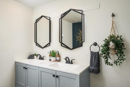 a bathroom with a white sink and two mirrors at Denver Emerald - Close to Red Rocks, Arvada & Downtown in Denver