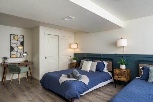 a bedroom with two beds and a table and a chair at Denver Emerald - Close to Red Rocks, Arvada & Downtown in Denver