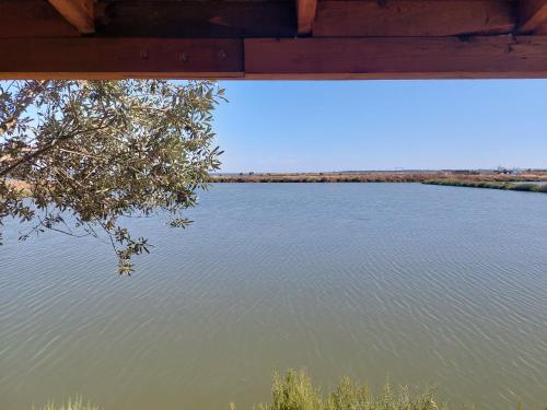 a view of a river from under a bridge at COMPORTA SIDE - Lake in Setúbal