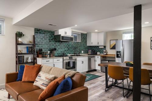 a living room with a couch and a kitchen at Denver Emerald - Close to Red Rocks, Arvada & Downtown in Denver