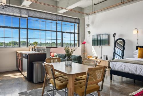 a room with a table and chairs and a bed at Large Studios, 1BR, Free Parking Gym, Game Room in Philadelphia