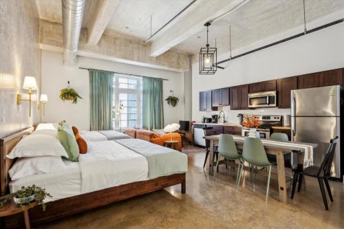 a bedroom with a large bed and a dining room at Large Studios, 1BR, Free Parking Gym, Game Room in Philadelphia