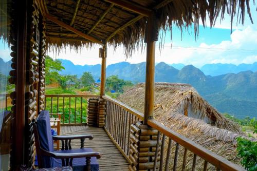 a porch of a cabin with a view of mountains at Pu Luong Jungle Lodge in Pu Luong