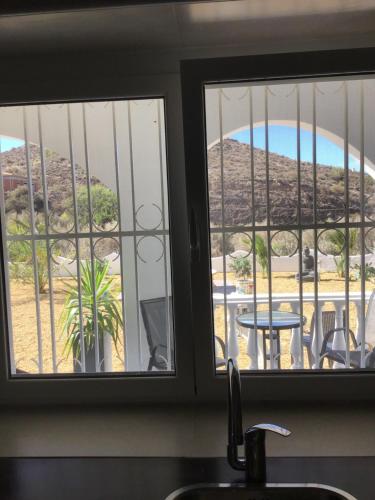 a kitchen window with a view of a table at Cortijo Los Corazones in Cantoria
