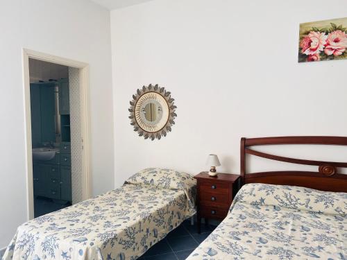 a bedroom with two beds and a mirror on the wall at Casa Francesca - Immobilevante in Ponza