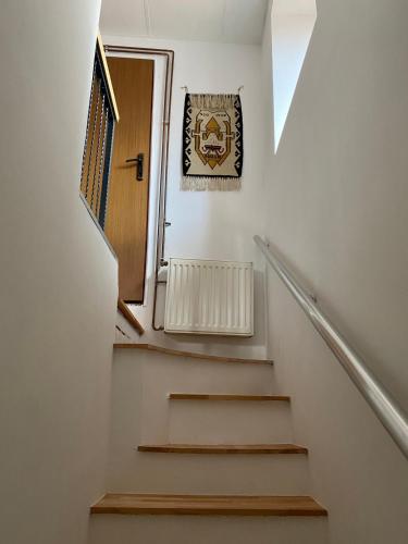 a stairway with a wooden door and a window at Apartman ''Trg'' in Tuzla
