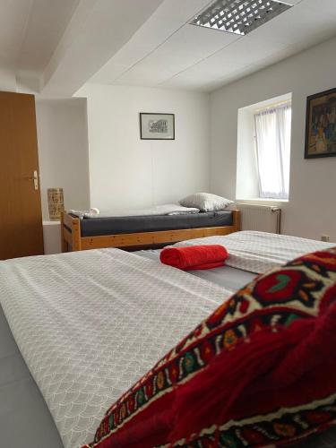 a bedroom with two beds and a window at Apartman ''Trg'' in Tuzla