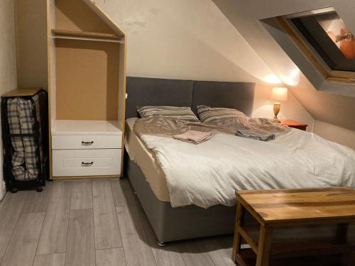a bedroom with a large bed and a table at BFamily-Jacks Court in Stalybridge