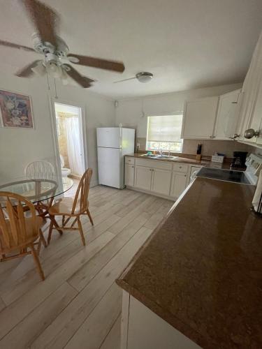 a kitchen with a table and chairs and a counter top at Kings Kamp in Key Largo