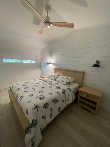 a bedroom with a bed and a ceiling fan at Kings Kamp in Key Largo