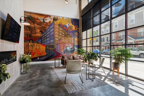 a living room with a large mural on the wall at Large Studios, 1BR, Free Parking Gym, Game Room in Philadelphia