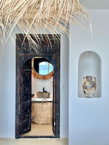 an ornate mirror in a room with a vase at Casa de oro Lujo in Sozopol