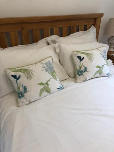 a bed with white sheets and two pillows at BELESME, PRIVATE ANNEX in Bridgnorth