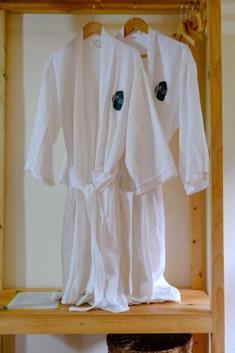 a white shirt hanging on a wooden shelf at Pu Luong Jungle Lodge in Pu Luong