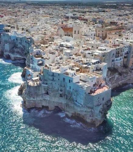 an island in the ocean with white buildings at Porto Antico in Bari