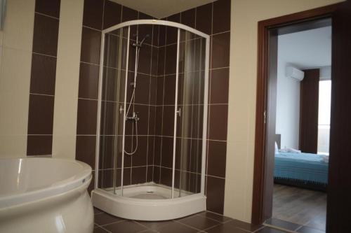 a bathroom with a shower and a toilet at SKY INFINITY in Balchik