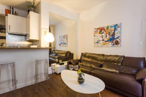 a living room with a couch and a table at GuestReady - Artsy Flat for 2 near Opera in Paris