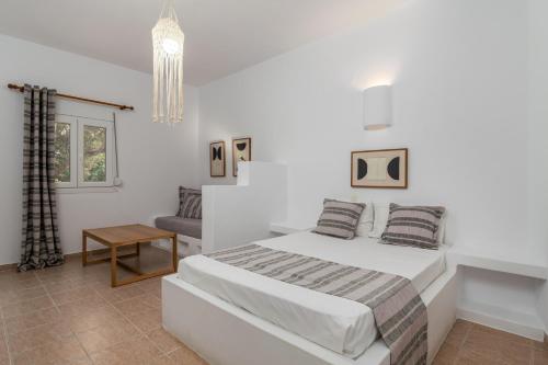 a white bedroom with a bed and a couch at Summer Residence in Provatas