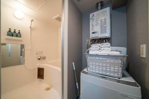 a small bathroom with a washing machine with towels at W401 Near the center of Sapporo, Japanese style in Sapporo