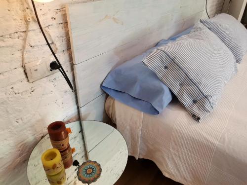 a room with a bed with a table and a bed with at Women Only - Solo Mujeres in Seville