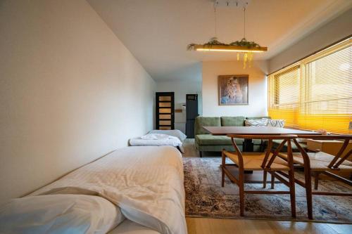 a bedroom with a bed and a table and a couch at W401 Near the center of Sapporo, Japanese style in Sapporo