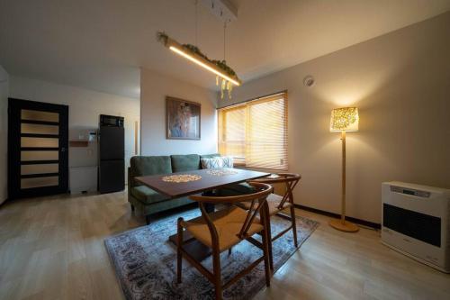 a living room with a table and a couch at W401 Near the center of Sapporo, Japanese style in Sapporo