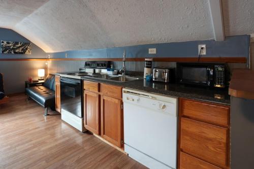 a kitchen with a sink and a stove top oven at Pool-Table-Hot Tub-Fire Pit in Glasgow