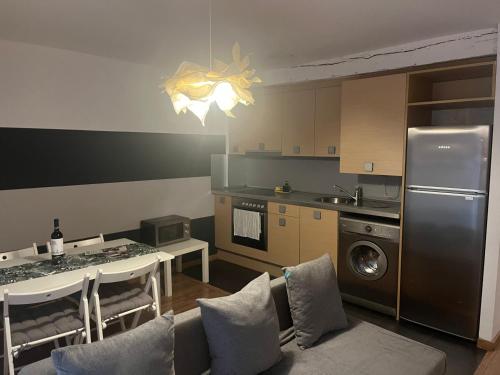 a kitchen with a refrigerator and a table with chairs at Casa Latre Somontano in Barbastro
