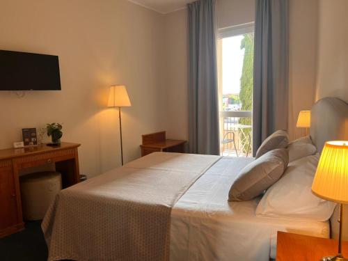 Posteľ alebo postele v izbe v ubytovaní Hotel Dorè