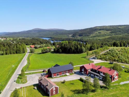 an aerial view of a house in a field with a road at Millestgården Eco lodge in Duved