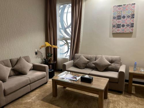 a living room with two couches and a coffee table at Holiday Villa Hail in Hail