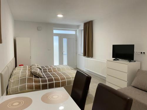 A bed or beds in a room at Apartmány Silvia