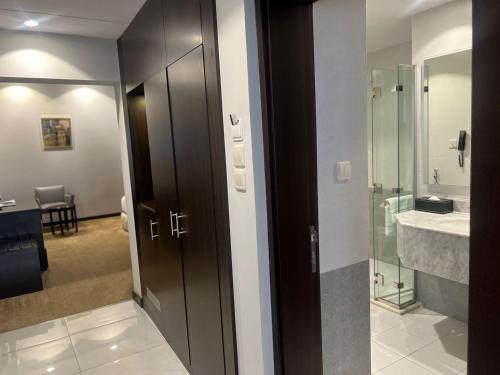 a bathroom with a glass shower and a sink at Holiday Villa Hail in Hail