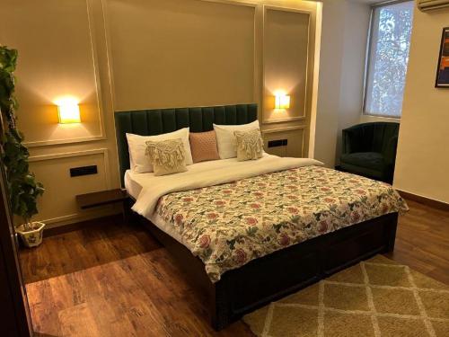 a bedroom with a large bed with a green headboard at Gulmohar Mansion - A Boutique Stay in Jaipur
