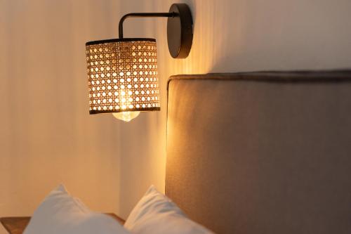 a bedroom with a lamp and a bed with white pillows at Summer Residence in Provatas