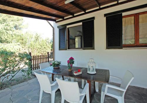 a wooden table and chairs on a patio at Casa Katia, Giuliana & Nami in Lacona