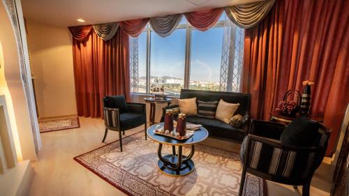 a living room with a couch and a large window at Holiday Villa Hail in Hail