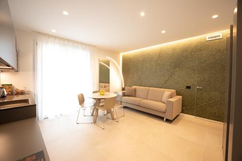 a living room with a couch and a table at Midum LuxuryApartments con giardino in Trento
