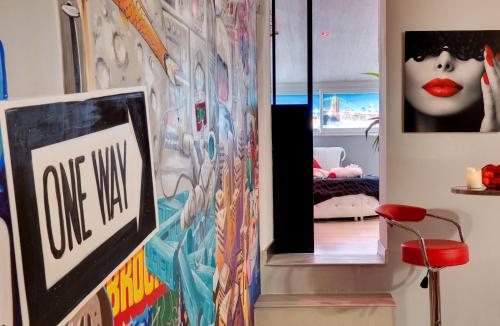 a hallway with a painting of a woman on the wall at SUITE BROOKLYN JACUZZI in Vichy