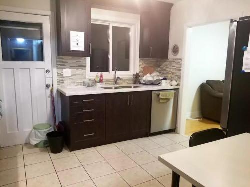 a kitchen with a sink and a counter top at Private Rooms, Free Parking, Full Kitchen, Best Prices in Town- York University Heights in Toronto