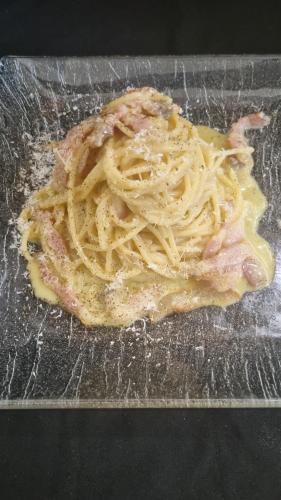 a plate of food with pasta on a table at Hotel terme di orte in Orte
