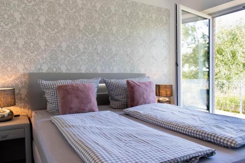 2 camas sentadas junto a una ventana en un dormitorio en Ferienwohnung Sonnentanz en Timmendorfer Strand