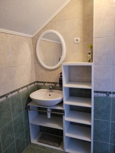 a bathroom with a sink and a mirror at Holiday house SuPer in Slunj