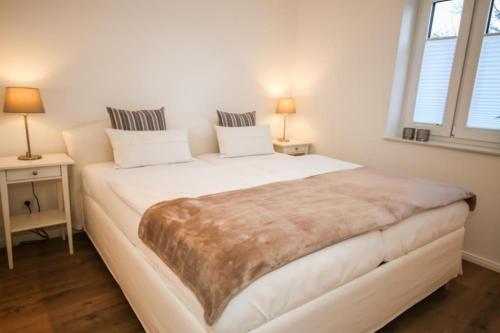 Кровать или кровати в номере Ferienwohnung Küstentraum
