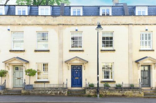 a large white house with a blue door at Spacious Townhouse Private Parking Central Wells in Wells