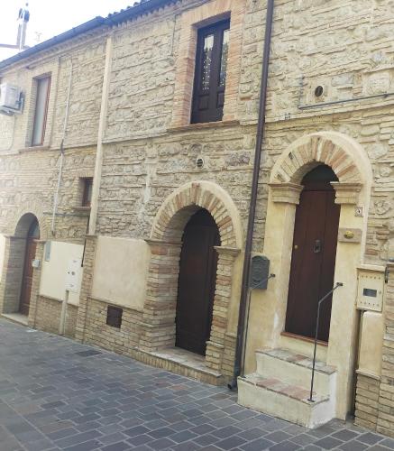 an old stone building with arches on a street at Casa Nicolì in San Salvo